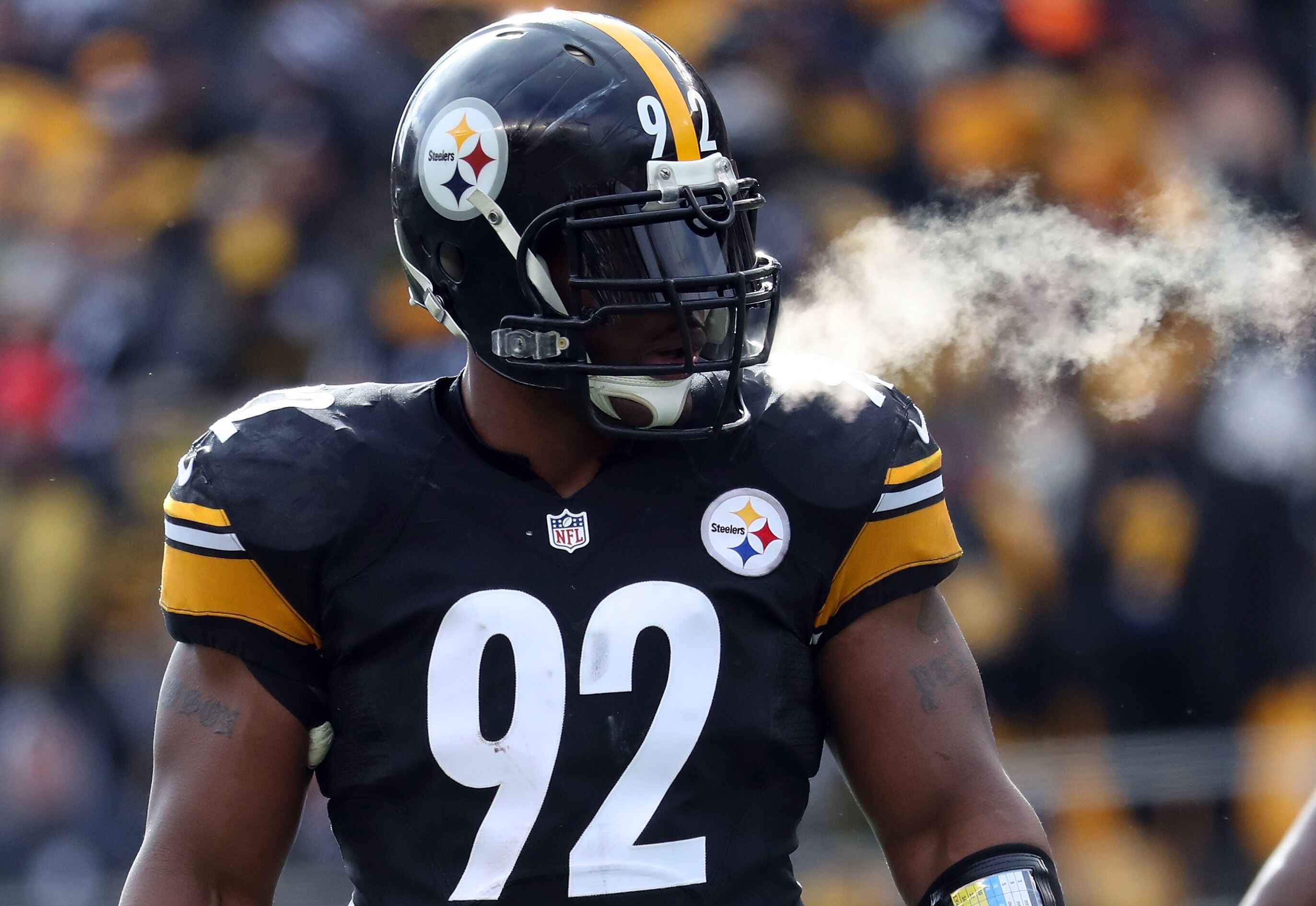 Former Pittsburgh Steelers linebacker James Harrison, right, talks with  defensive lineman Aaron Smith during a halftime ceremony honoring former  Steelers players during halftime of the NFL football game between the  Pittsburgh Steelers