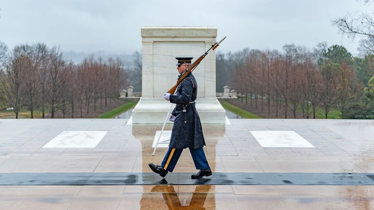 FILE PHOTO: A sentinel walks the mat in front of the Tomb of the Unknown Soldier during a rainy day at Arlington National Cemetery, Arlington, Virginia, Feb. 25, 2020. The sentinels are still fulfilling their mission despite the COVID-19 outbreak.